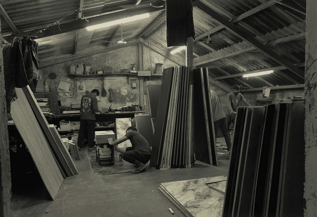 Workers in a workshop with stacked materials